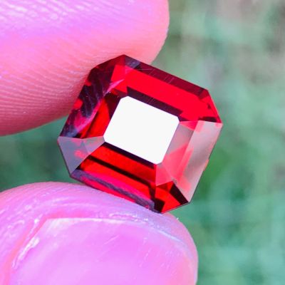quelqu'un tient un petit diamant rouge dans la main