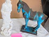 a statue of a horse and a statue of a man on a table