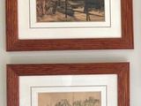 two framed pictures hanging on the wall of a room