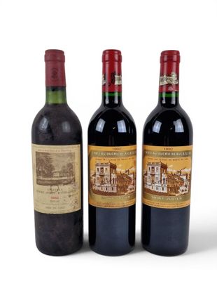three bottles of wine sitting next to each other on a white surface