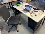 a desk with a computer and a laptop on it