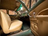 a tan leather seat in the back of a green car