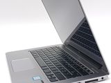 a silver laptop with a blue sticker on the screen