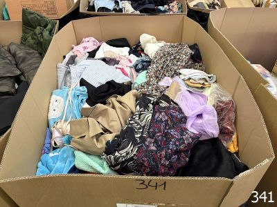 a cardboard box filled with clothes and other items