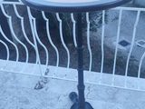 a small table that is on the balcony of a house