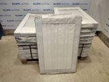a stack of mattresses sitting on a pallet in a warehouse