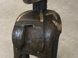 an old wooden statue of a horse with a helmet on it ' s head