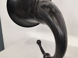 a very old black phonom that is on a table