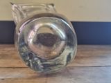 a glass vase sitting on top of a wooden table