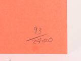 someone is writing on a piece of orange paper with a pen