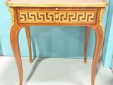 a small wooden table with a drawer on top of it