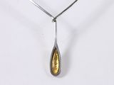 a close up of a silver and gold necklace on a white background