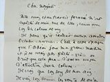 a handwritten letter on a piece of paper on a table
