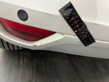 a sticker on the back of a white car