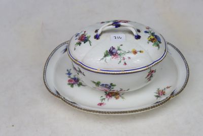 a white plate with a bowl and saucer on it