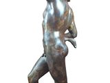bronze statue of a man holding a tennis racquet on a marble base