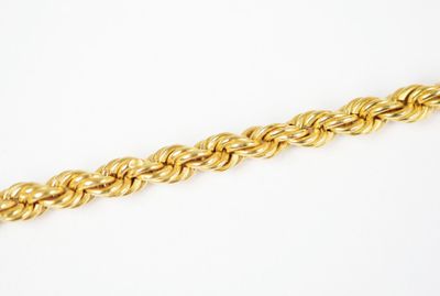 a close up of a gold chain on a white background