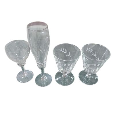 three clear glass goblets and a wine glass on a white background