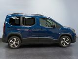 the blue van is parked in a room with a gray floor