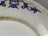 a plate with a blue and white design on it