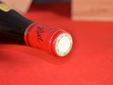 a bottle of wine on a table with a red cloth