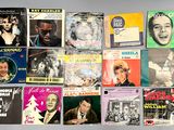 several different records are stacked on top of each other on a table