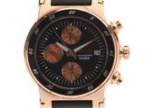 a close up of a black and gold watch on a white background