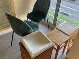 two chairs and a table in a room with a large window