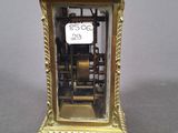 a gold clock that is sitting on a table