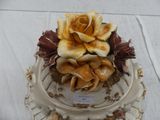 a white plate with a flower on top of it