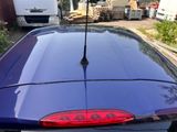 an image of a blue car parked in a lot