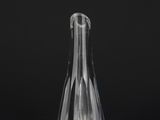 a clear glass vase sitting on top of a black table