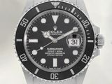 a watch with a black dial on a stainless steel bracelet