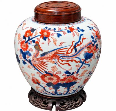un grand vase orné d'un oiseau, posé sur un socle