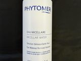 a close up of a bottle of water on a black surface