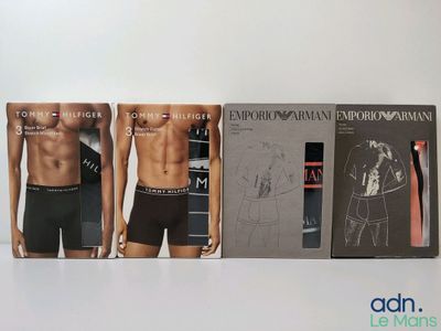 three men ' s underwear boxes are lined up on a white surface