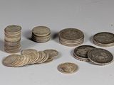a pile of coins sitting on a table next to a pile of coins