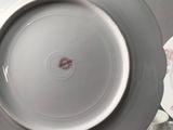 a plate with a bird on it sitting on a table