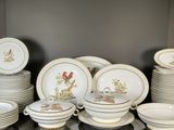 a lot of plates and bowls that are on a table