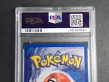 the pokemon card is in a plastic holder on a table