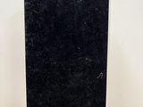 an image of a black and white marble plaque on a wooden table