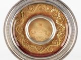 a silver and gold plate with a picture on it