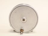a small metal object that is sitting on a white surface