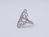 a close up of a diamond ring on a white surface