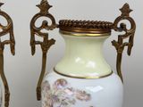 two vases that are sitting side by side on a table