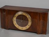 a wooden clock that is sitting on a table
