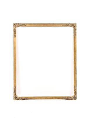 a gold frame on a white wall with a white background
