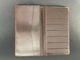 a brown leather wallet sitting on top of a table