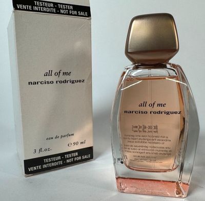 an image of a bottle of perfume next to a box