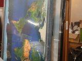 a man that is looking at a map on the wall